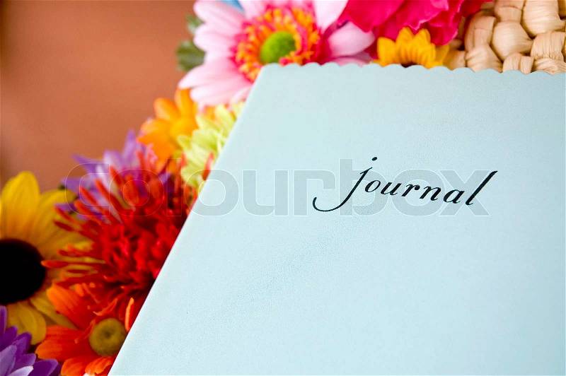 Blue journal with colorful flowers, stock photo