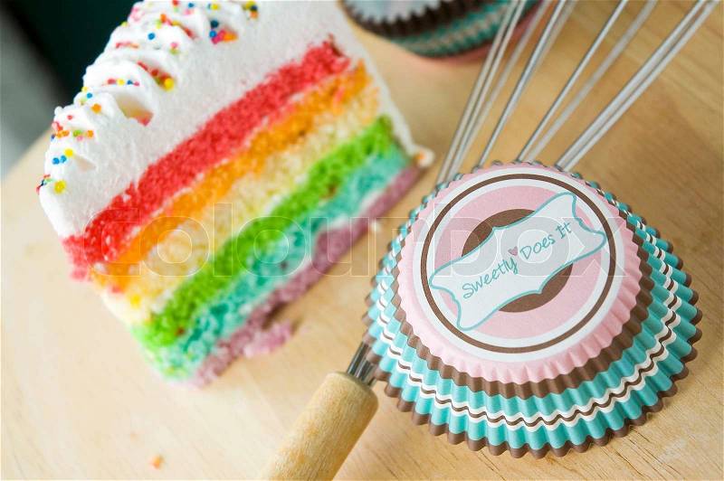 Sweet cup for cupcake with rainbow cake background, stock photo