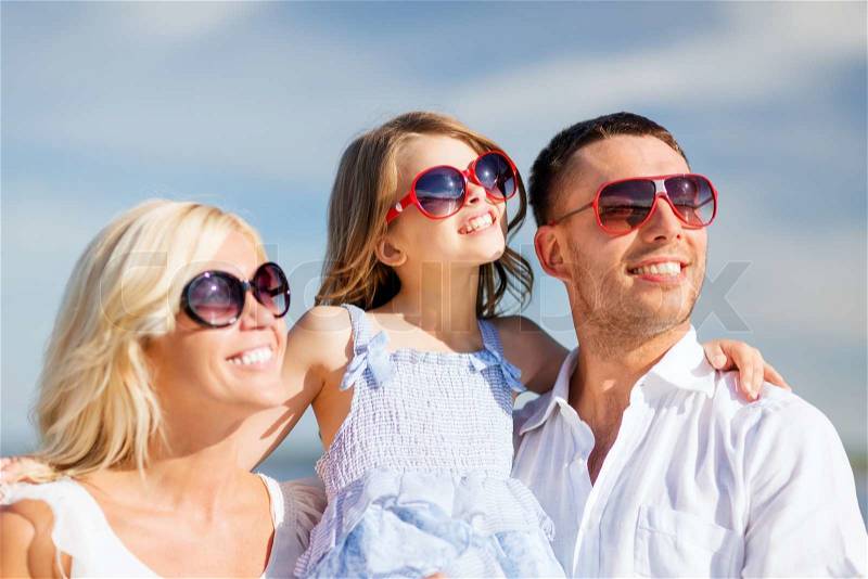 Summer holidays, children and people concept - happy family with blue sky, stock photo