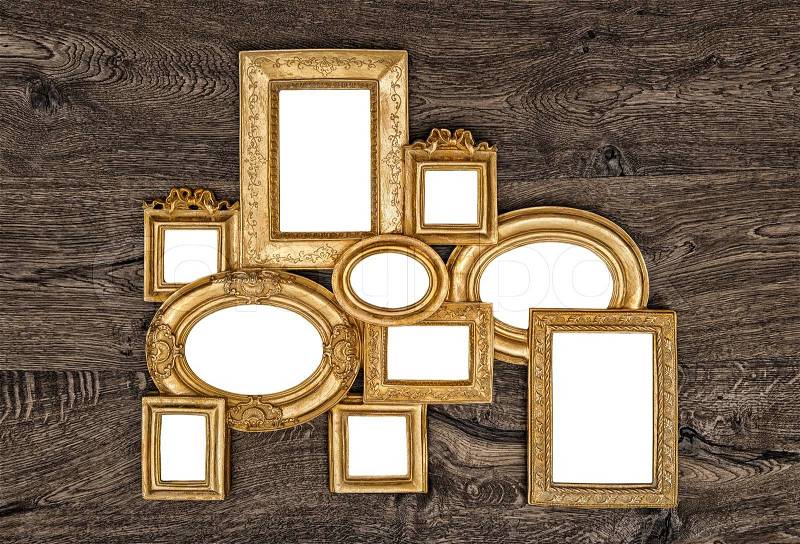 Antique golden frame over rustic wooden background. empty baroque frame for photo and picture, stock photo