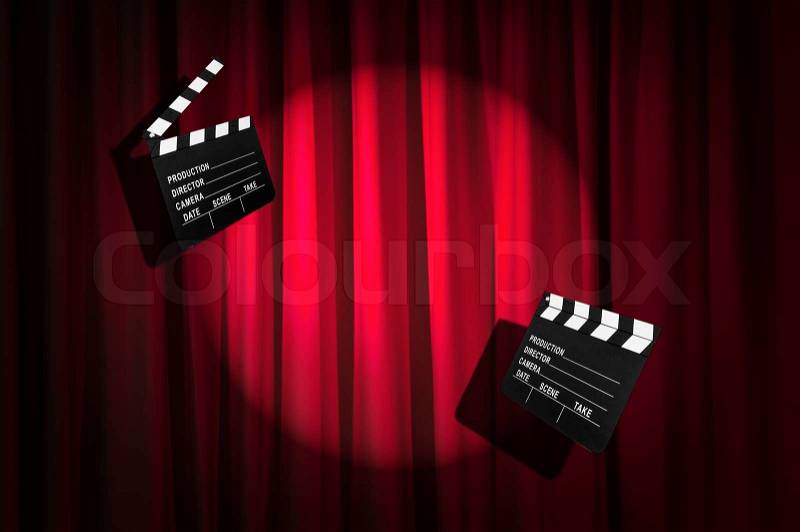 Movie clapper board against curtain, stock photo