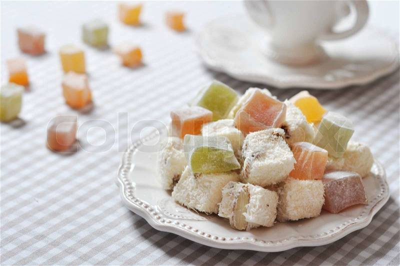 Turkish delight with nuts on checkered tablecloth closeup, stock photo