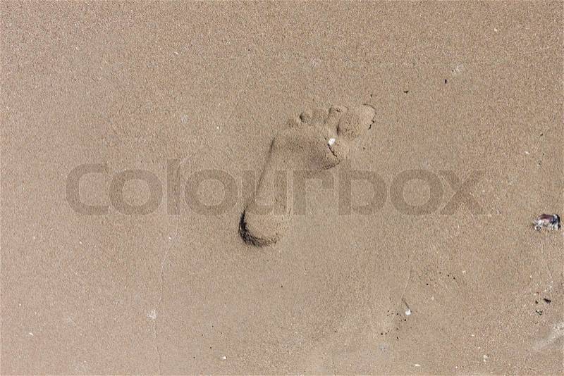 Human footprint on the sandy beach, stock photo