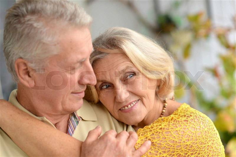 Happy elderly couple posing in the room, stock photo