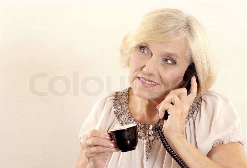 Portrait of a beautiful Mature Woman speaking on the phone, stock photo