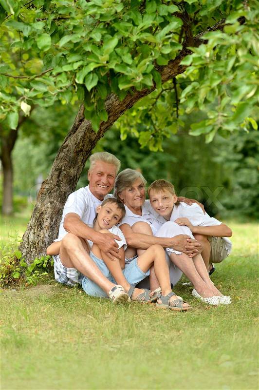 Family under a tree, stock photo