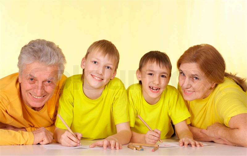 Cool family in yellow t-shirts having a good time together, stock photo