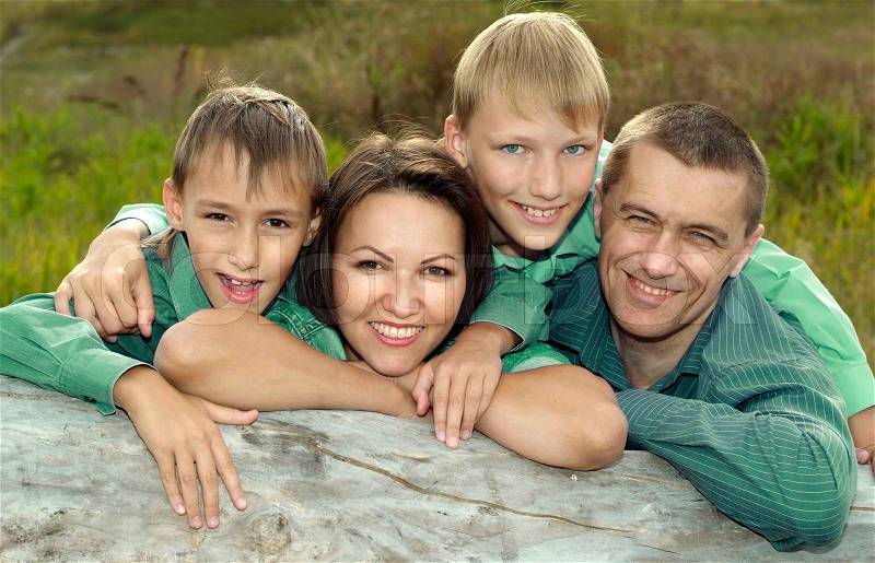 Family of a four playing at nature, stock photo
