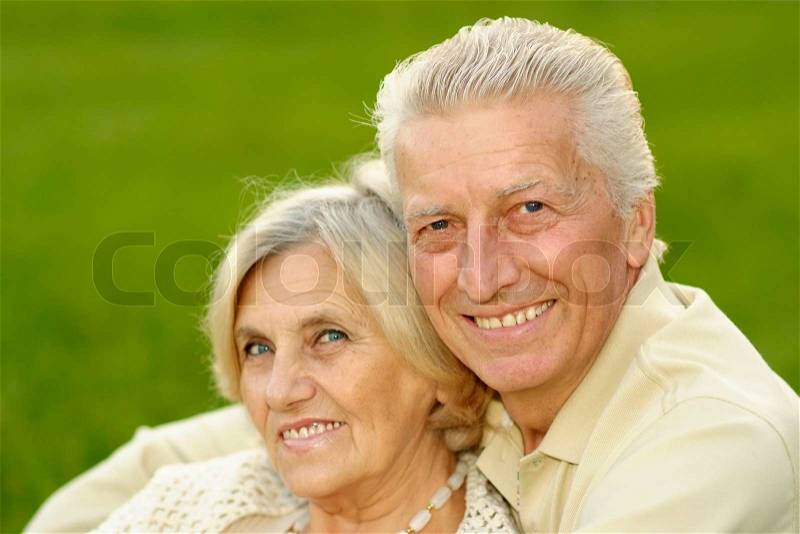 Happy cute couple sitting at autumn park, stock photo