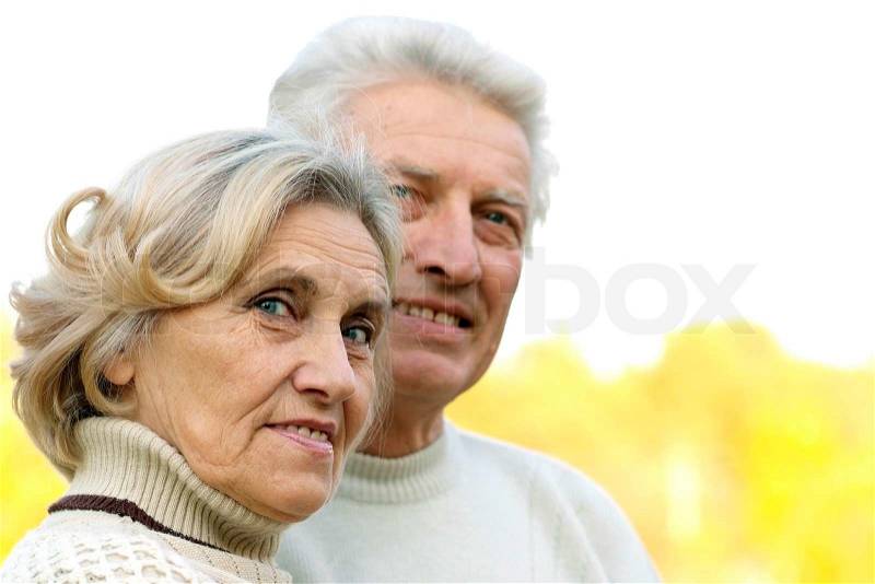 Portrait of a nice senior couple standing in park, stock photo