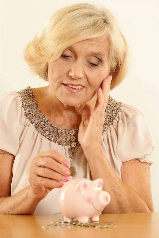 Happy woman with piggy bank, stock photo