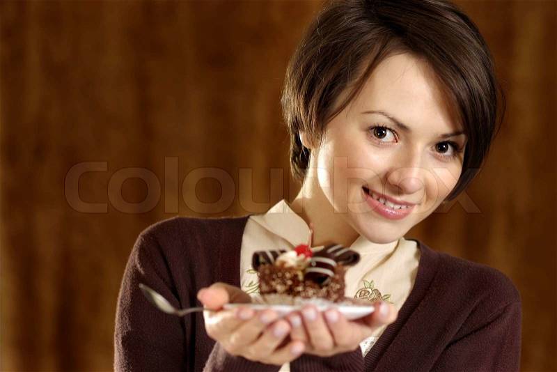 Portrait of a nice woman with a cake in hand, stock photo