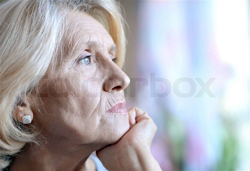 Close-up portrait of an old European woman thinking about something, stock photo