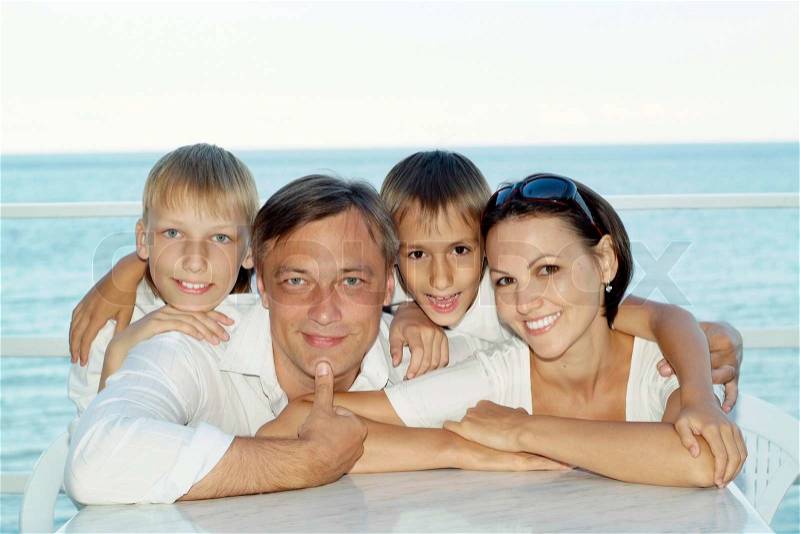Portrait of a happy family of four on a summer holiday, stock photo