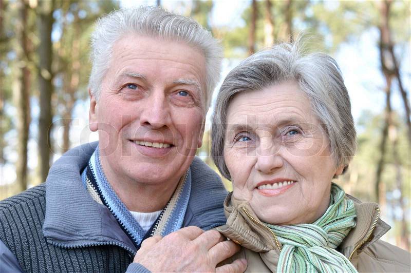 Happy elder couple on a walk in the forest in the spring, stock photo