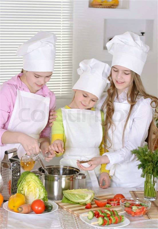 Girls preparing dinner, stock photo