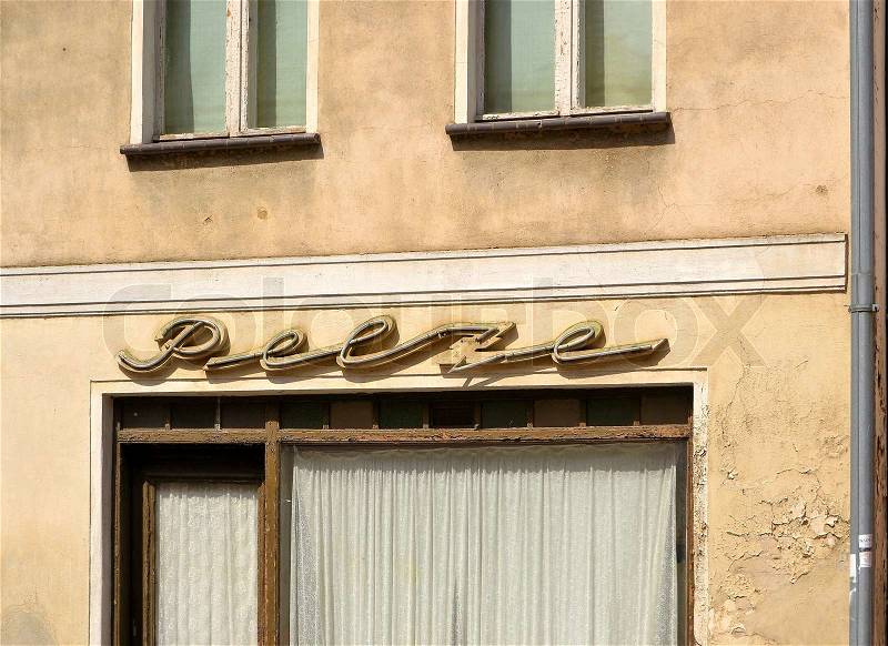 Neon sign with the words furs at an abandoned shop in the old town of Brandenburg, stock photo