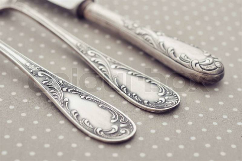Fork, spoon and knife on light polka dot background. , stock photo