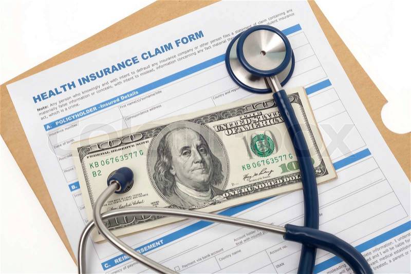 Medical reimbursement with health insurance claim form and stethoscope on cash isolated, stock photo