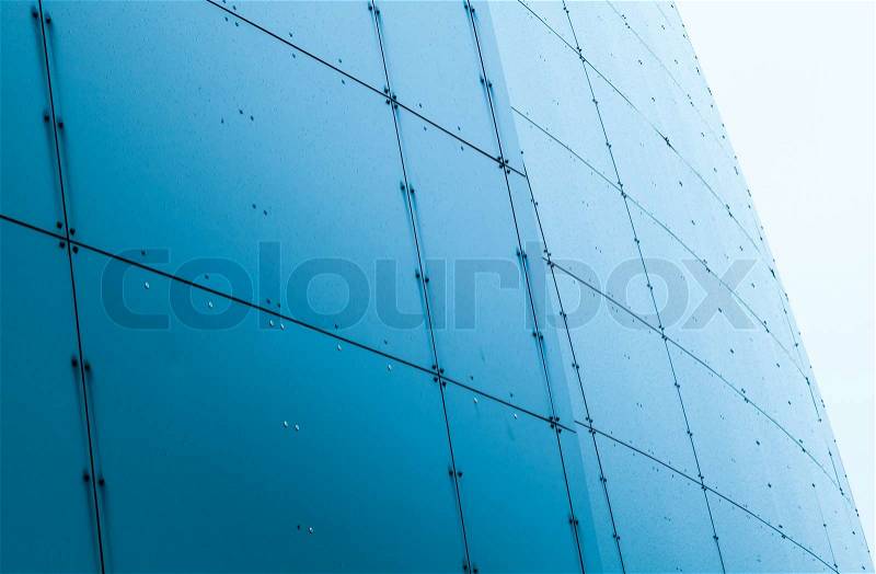 Abstract architecture fragment with blue wet steel panels, stock photo
