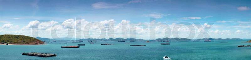 Panorama cargo ship in sea.Cargo ships parked in the lot near the sea Island on Clear Cloud, stock photo
