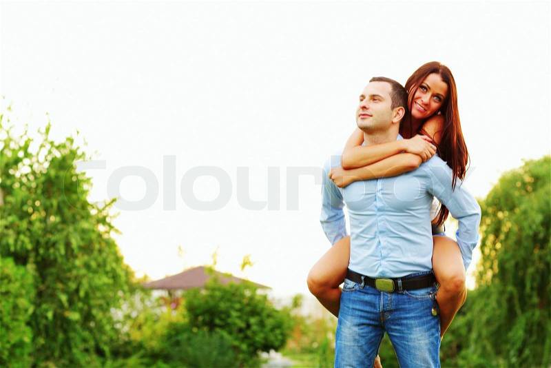 Happy woman jumped on man\'s back, stock photo
