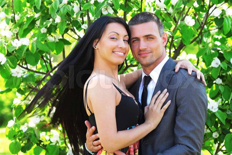 Portrait of beautiful young couple in the park in sunny weather, stock photo