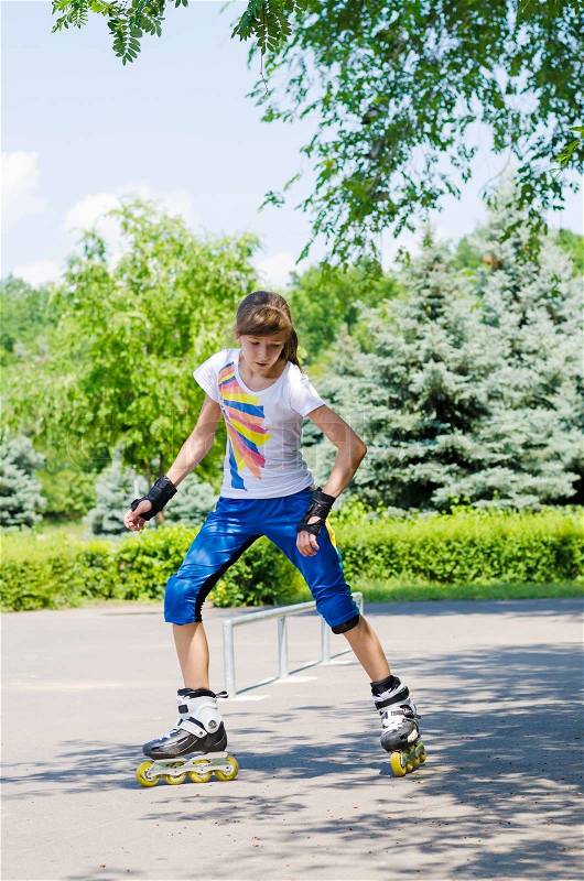 Pretty teenage girl skating in a skate park, stock photo