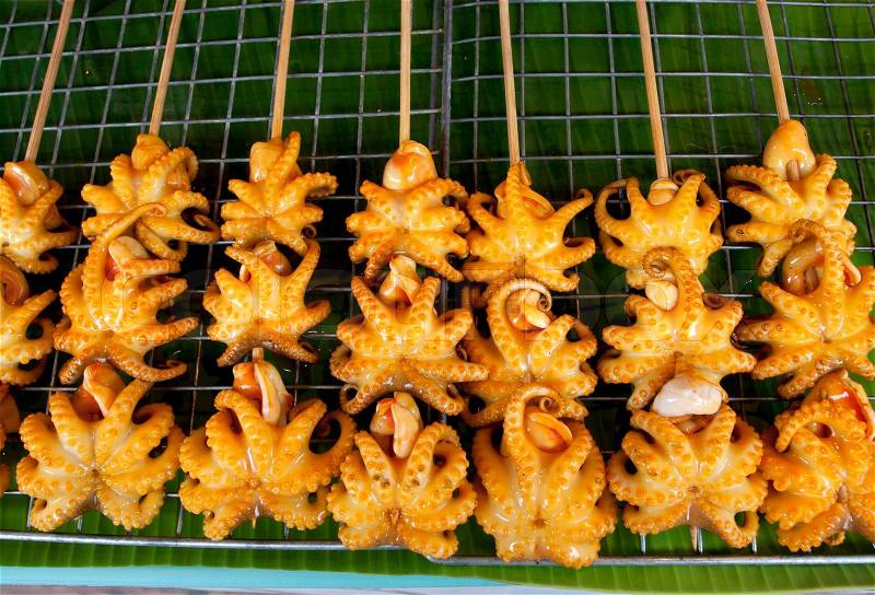 Grilled Squid, Thailand Food - Barbecue from squids sold on the warter market, stock photo