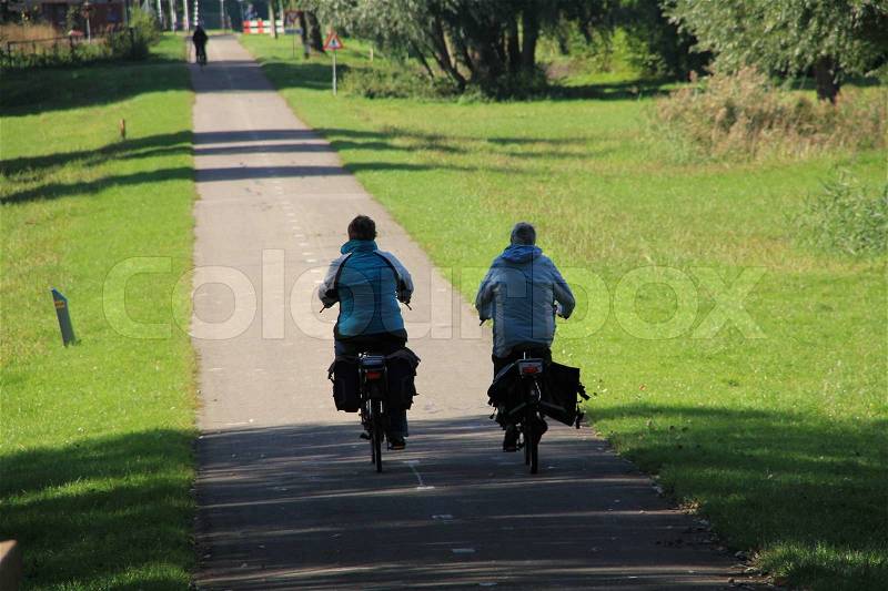 Two ladies, two bikes, stock photo