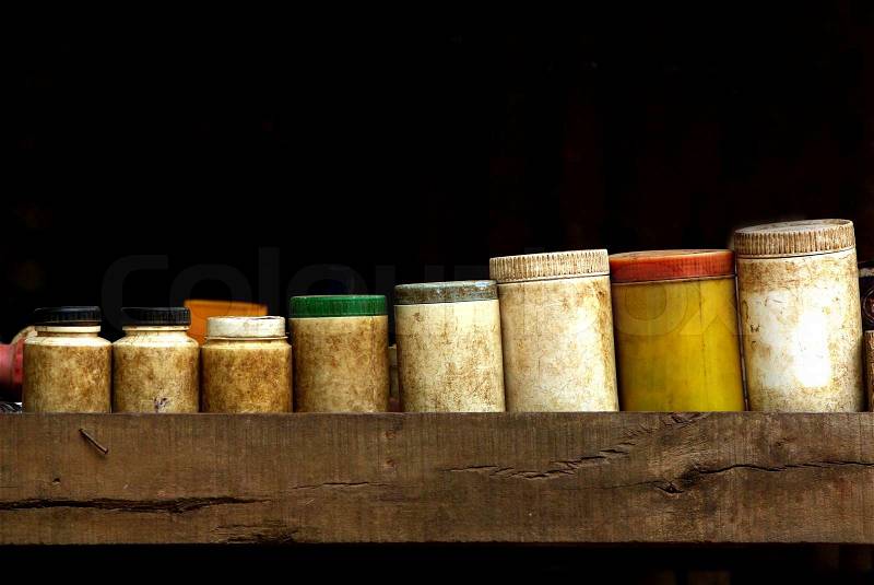 Old medical containers on black background in Provincial, stock photo