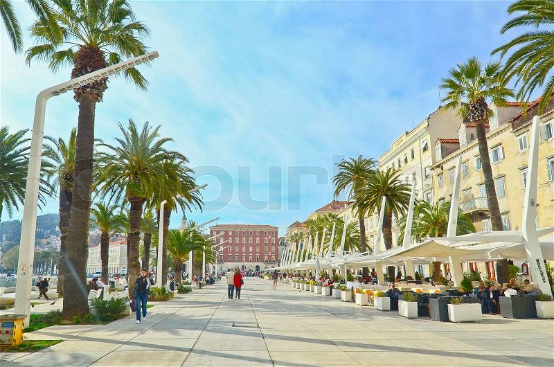 SPLIT, CROATIA - MARCH 22: People walk the old waterfront on March 22, 2012 in Split, Croatia. In 2012 11.2 million tourists visited Croatia, most of them in summer, stock photo