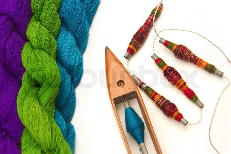 Spool of thread and wooden bobbin with raw thread ,accessory of cloth weaving, stock photo