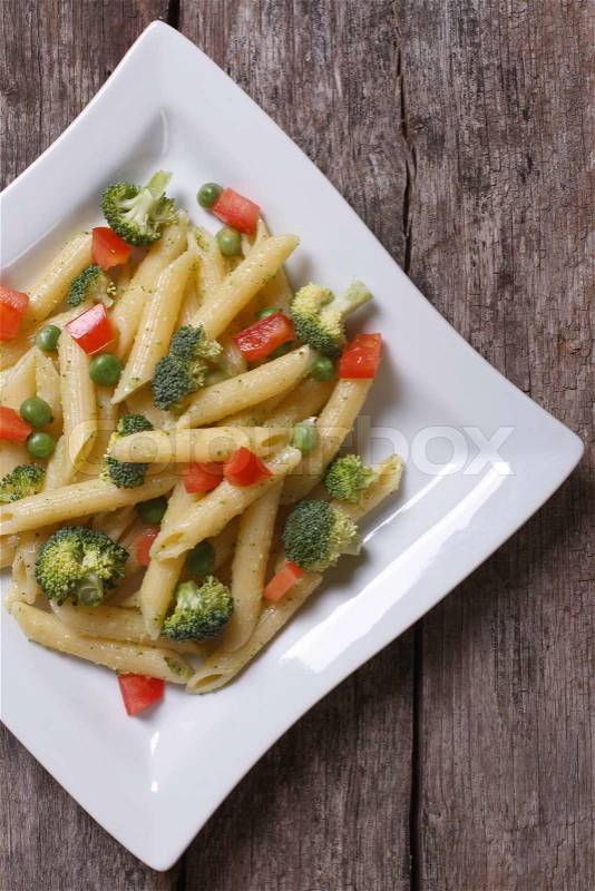 Pasta with vegetables on the table in a square plate top view, stock photo