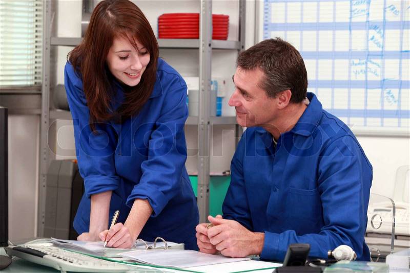Factory workers working in the office, stock photo