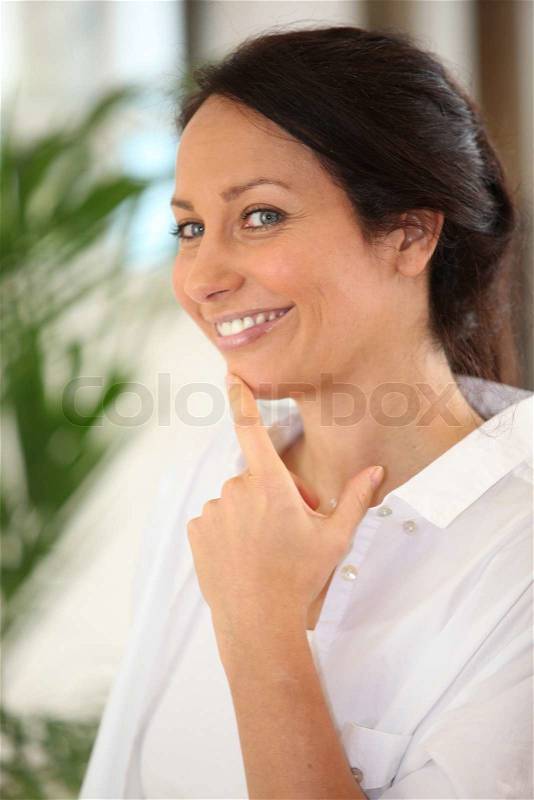 Brunette with finger on chin, stock photo