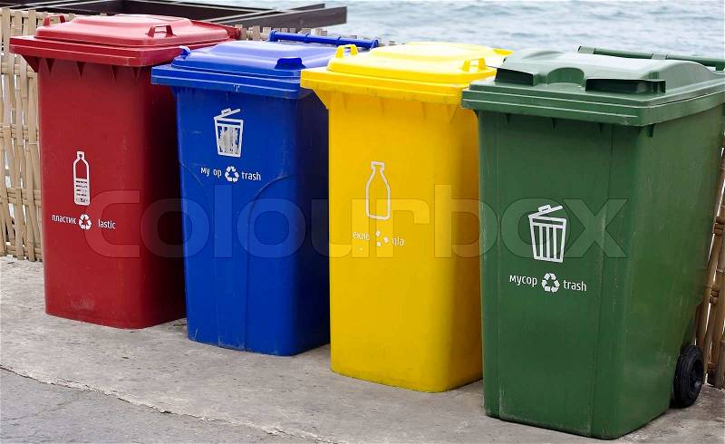 Four color trash cans in the park beside the walk way, stock photo