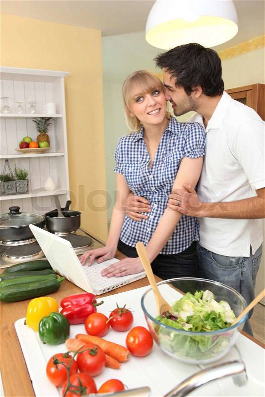 Couple following on-line recipe, stock photo