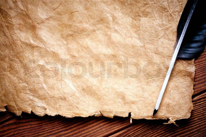 Quill pen on paper scroll, stock photo
