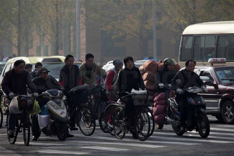 Chinese people on bicycles in the city of Shanghai, stock photo