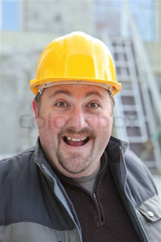 Excited chubby manual worker, stock photo