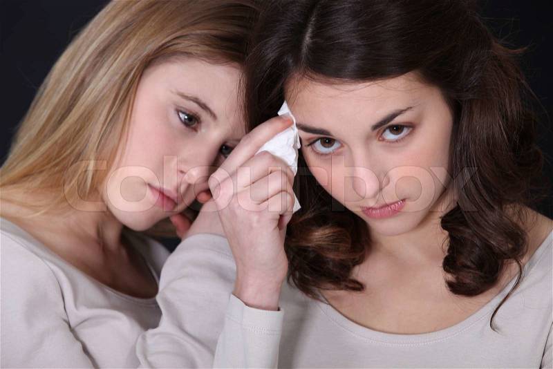 Two sisters upset after fight, stock photo