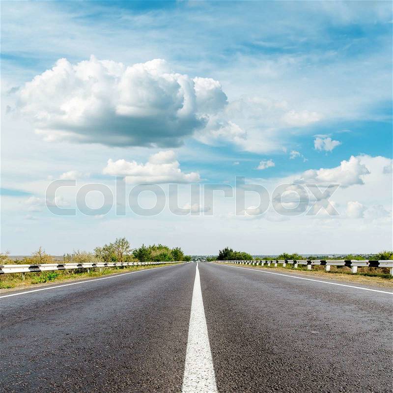 Asphalt road and clouds over it, stock photo