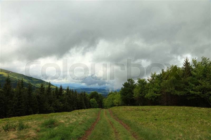 Mountain landscape. Pathway and storm clouds in the mountains, stock photo