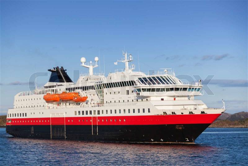 Big Norwegian passenger cruise ship goes on fjord, stock photo