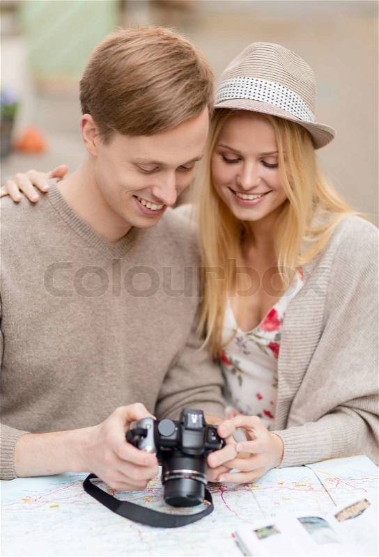 Summer holidays and dating concept - couple with photo camera at cafe in the city, stock photo