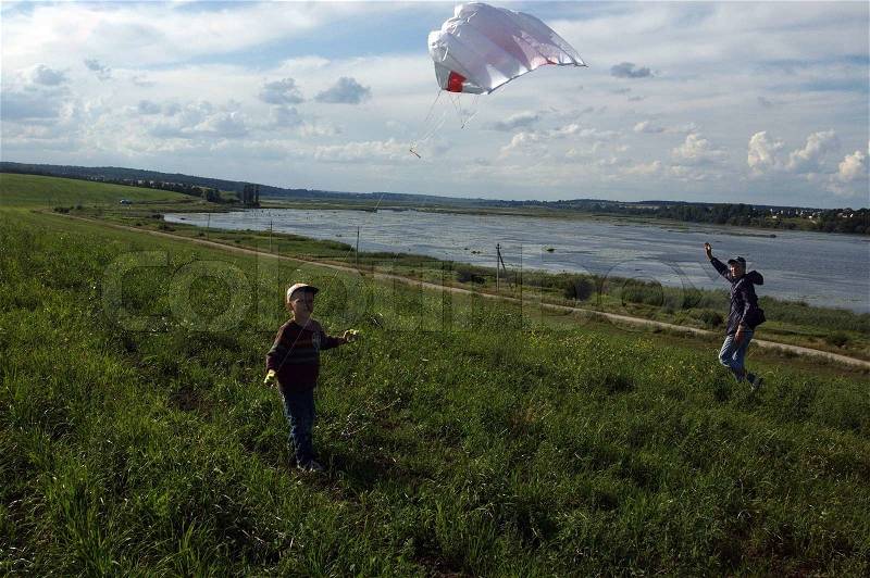 A boy with a flying kite, stock photo