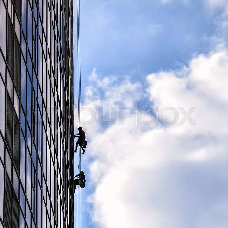 Builders of the tallest building in Kiev on high-altitude works, stock photo