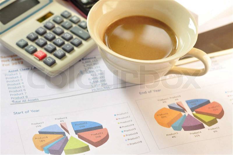 Coffee on financial statements and line chart, stock photo