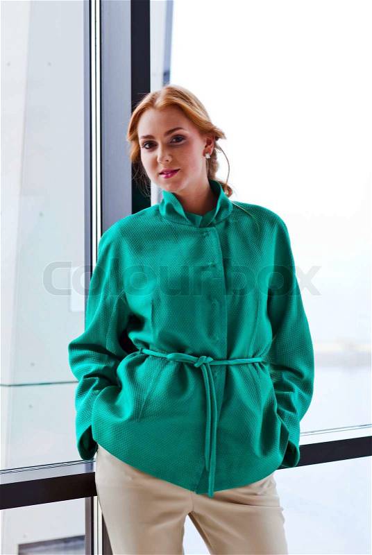 Young beautiful woman in green jacket, stock photo